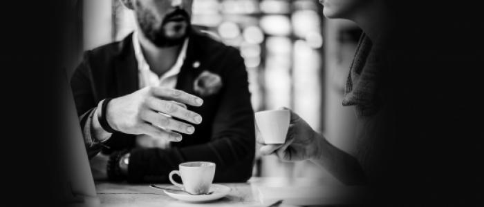 An image of a business meeting over coffee